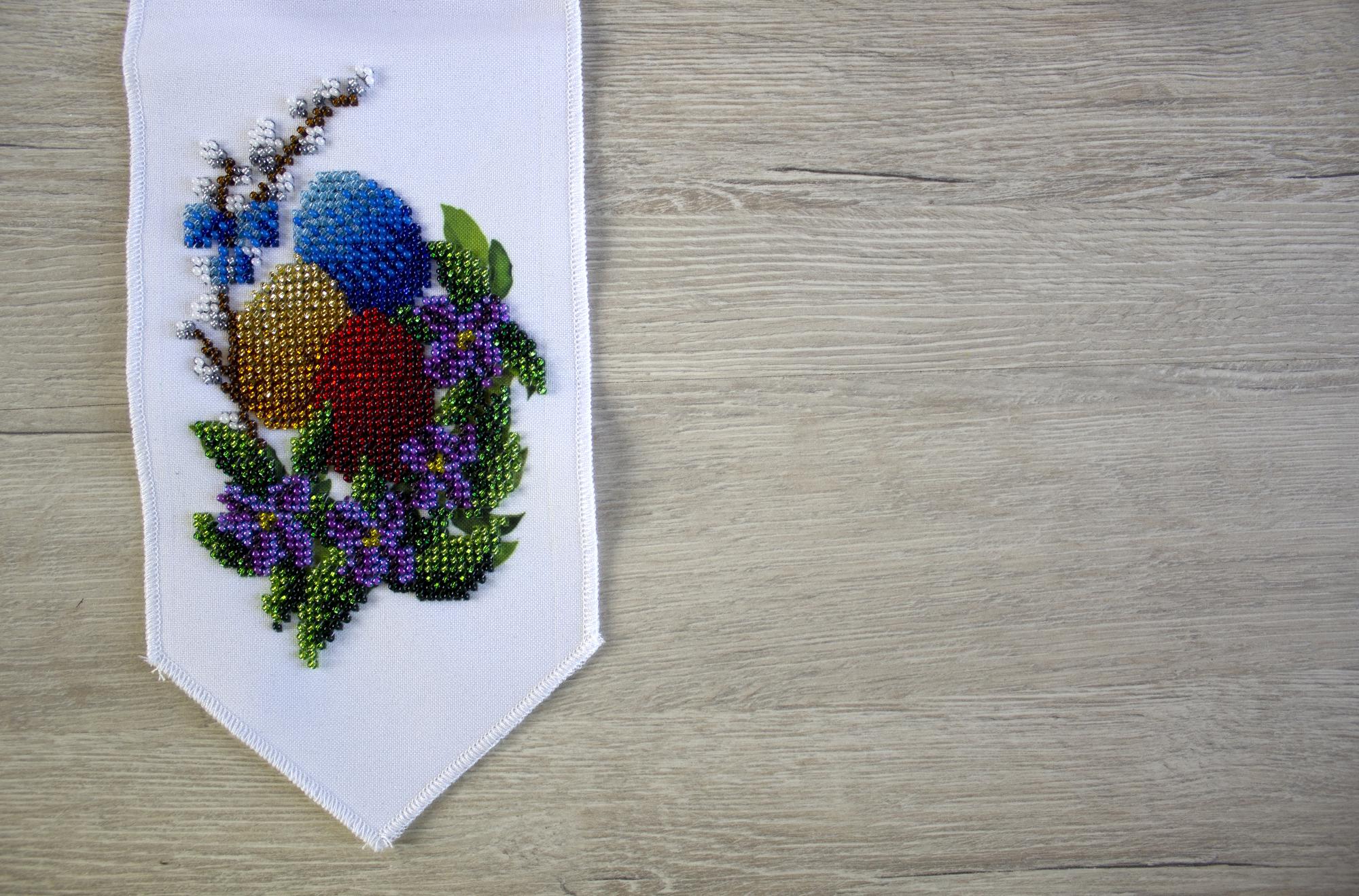 Samples of embroidered badges laid out on table